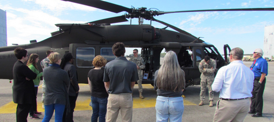 Spectators listen as Army CW4 describe a Blackhawk Helicopter.
